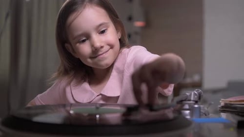 Happy Girl Plays Vinyl Record at Home