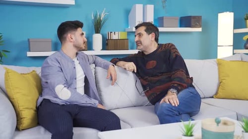Two People Talking on a Couch