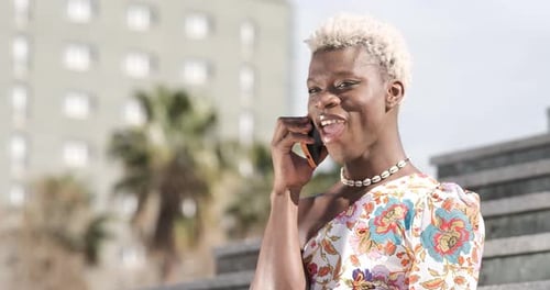 Transgender Person Talking on Mobile Phone Outdoors
