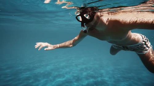 Boy Snorkels with Mask in the Open Sea