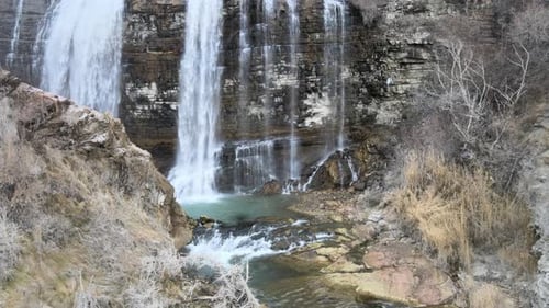 Waterfall Cascades Down Rocky Cliffside