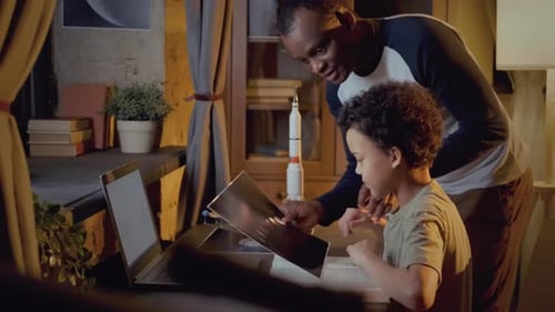 Father Helping Son with Science Homework at Home