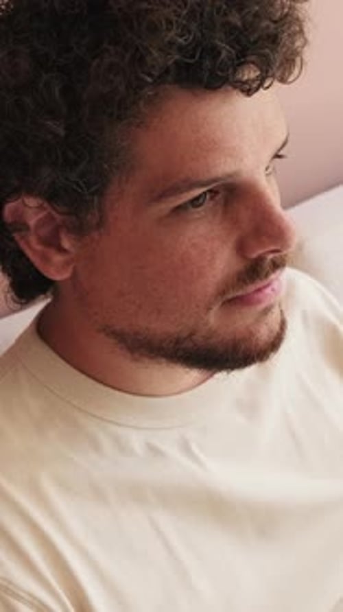 Close up, guy relaxing sitting on the sofa in cozy living room