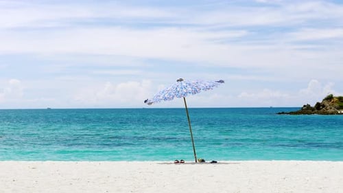 Umbrellas are fixed on the beach near the beautiful blue sea and the atmosphere is good with sea bre