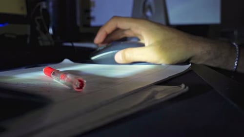 Man Using Computer Mouse In Dark Office
