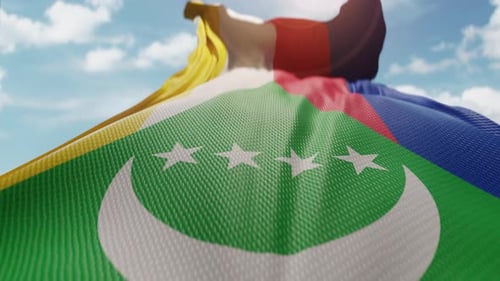 Realistic Comoros Flag Waving in Sunny Blue Sky