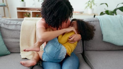 Mother and Daughter Embracing on the Couch