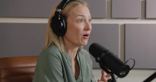 Female Podcaster Recording in a Studio, Radio talk show, wearing Headphones