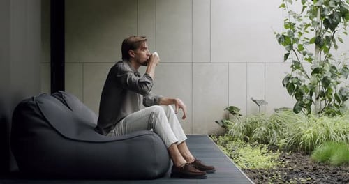 Man Drinking Tea on Terrace
