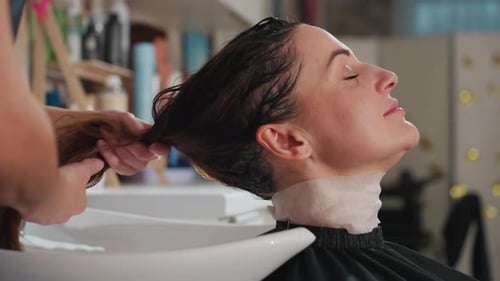 Woman getting her hair washed in salon