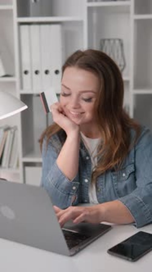 Woman Shopping Online with Credit Card at Desk