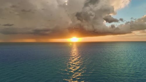 Dark Stormy Clouds Forming on Gloomy Sky During Heavy Rainfall Season Over Sea Surface in Evening