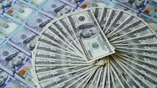 Dollars background. One hundred dollar banknotes rotating. Paper money spinning
