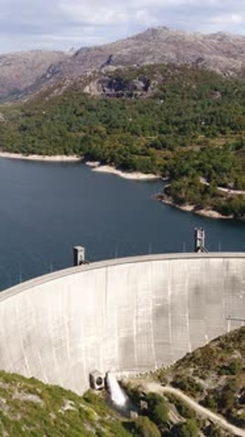 Vertical Video of Hydroelectric power station surrounded with mountains