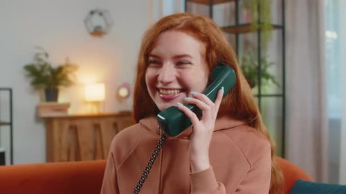 Cheerful Woman Talking on Retro Green Telephone