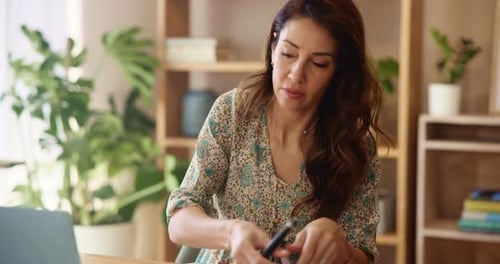 Woman Working at Laptop in Bright Home Office