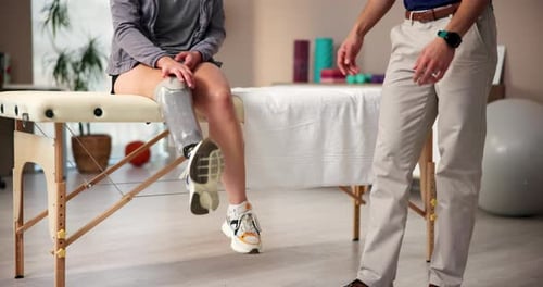 Prosthetic leg, consultation and physiotherapist with patient in rehabilitation center for mobility