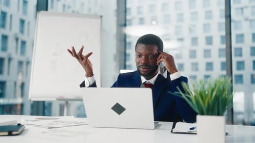 Angry Boss Calling By Mobile Phone to Employees or Partner Black Man in Office Portrait of Nervous