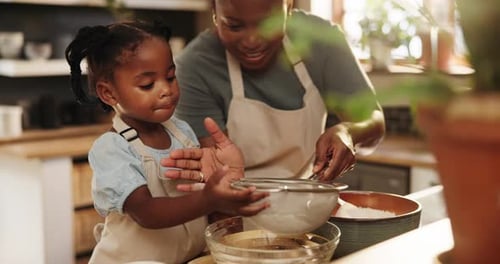 Child and Woman Baking Together in Kitchen