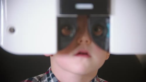 A Treatment in Eye Clinic Checking Little Boy's Eye