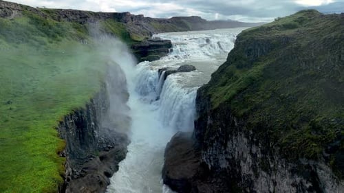 Majestic Gullfoss Waterfall Cascades Down Rocky Cliffs in Icelands Stunning Landscape