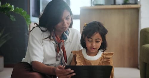 Woman and Child Using Tablet Together Indoors