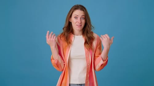 Unsure Woman Waves Arms As Sign of Not Knowing Answer