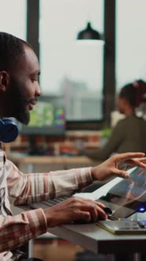 Man Working at Graphics Tablet Station in Office