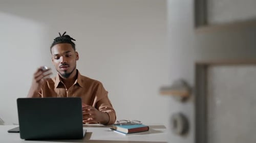 Young Adult Working at Laptop Inside Home