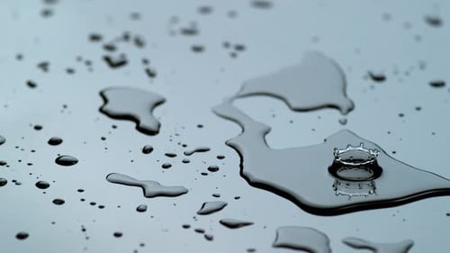 Water Droplets Falling and Rippling on Shiny Surface