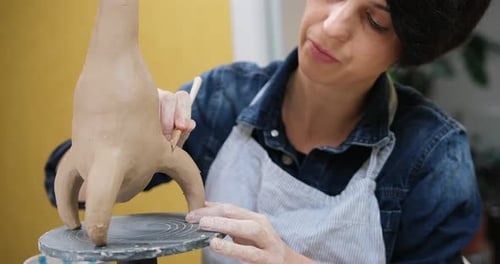 Woman Sculpts Vase From Clay By Hands Closeup in Artistic Studio