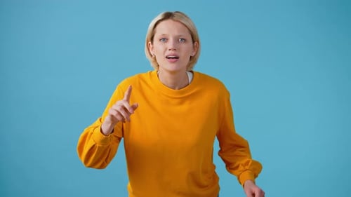 Expressive woman celebrates success in studio shot