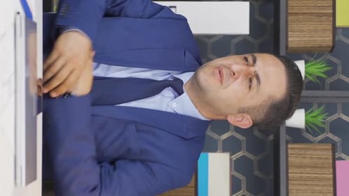 Man in Office Rubbing Shoulder in Pain