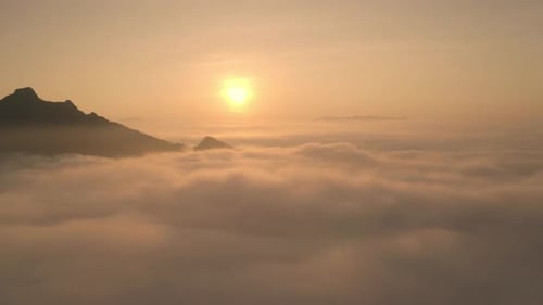 rone flight over the clouds during sunrise. Golden hour and amazing sun rays, beautiful cloudscape.