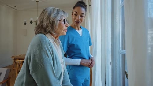 Senior Woman and Home Health Caregiver Conversation