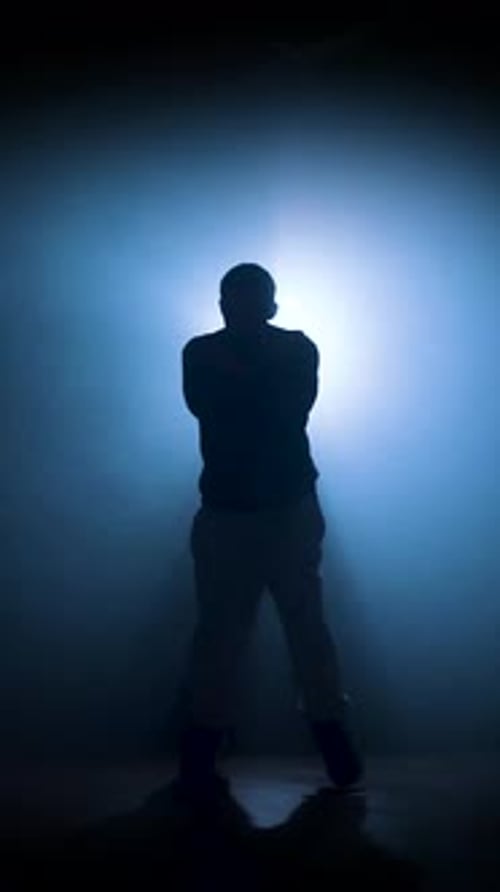 Silhouette of a Man Dancing Break Dance in a Dark Studio Dancer Artist Performing