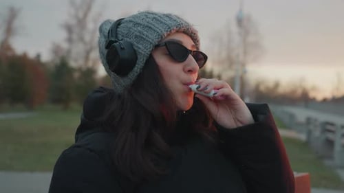 Gentle Sunset Tunes Enjoyed By Relaxed Woman Tranquil Dusk Scene Featuring Woman Reclining While
