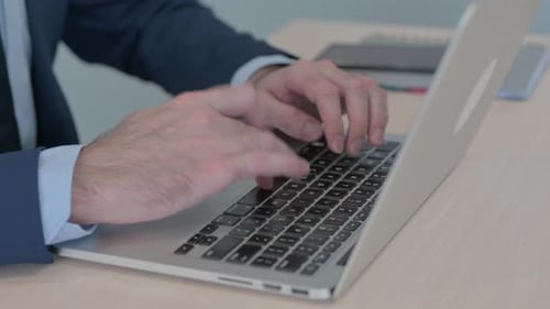 Close Up of Businessman Working on Laptop