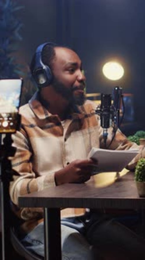 Man Recording Podcast in Studio at Night