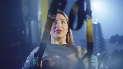 Caucasian Young Woman Doing Fitness and Doing Trx Exercises