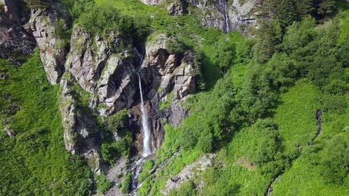 Waterfall in Green Alpine Mountains