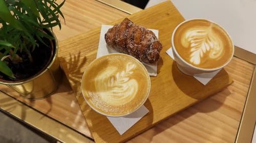 Closeup of a Cup of Coffee with Dessert on the Table Restaurant