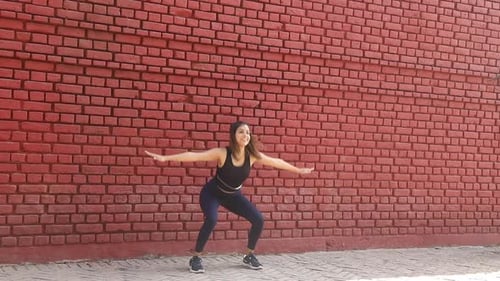 Woman Performing Squats and Balancing Exercise Outdoors