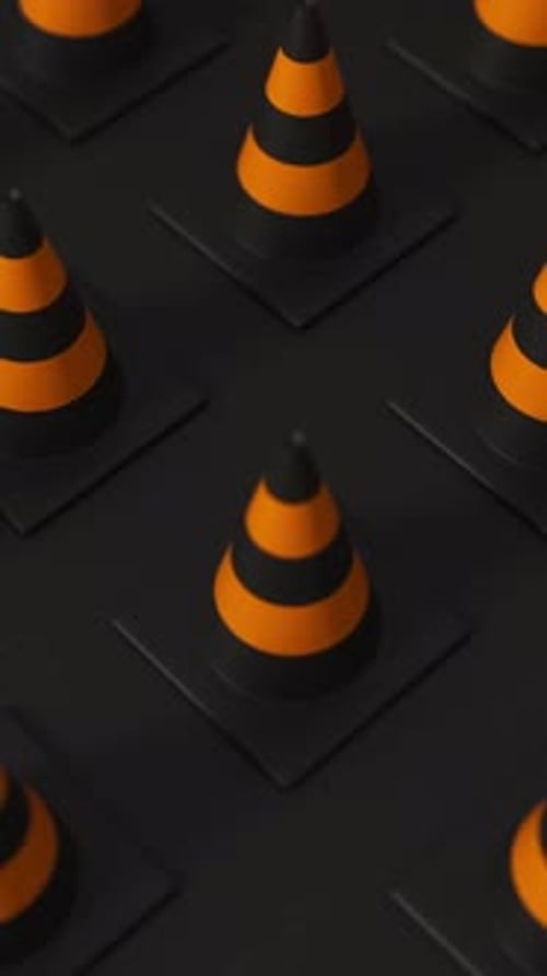 High Angle Grid of Traffic Cones in Orange and Black on a Black Background for Road Safety and
