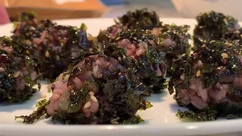 Seaweed rice balls on a white plate. A popular Korean snack for kids. Plate rotating to show each ri