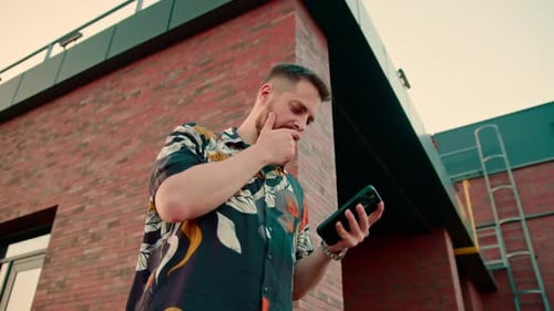 a man is holding a smartphone texting via instant messenger online video communication
