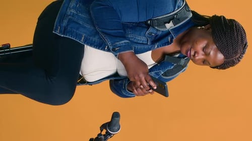 Woman Using Phone While Sitting, Portrait Orientation