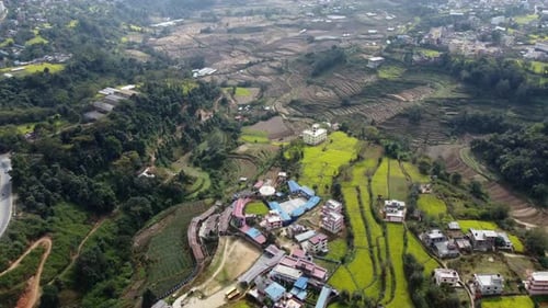 A beautiful aerial view of the small town of Dakshinkali, Nepal surrounded by mustard fields and the