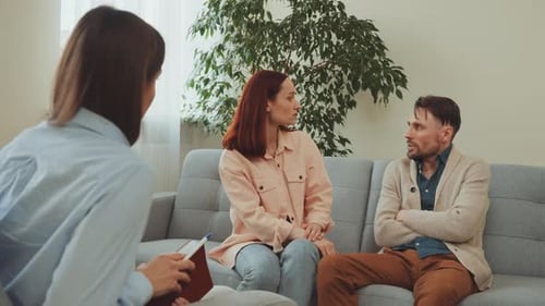 Couple Discussing Issues with a Counselor in Office