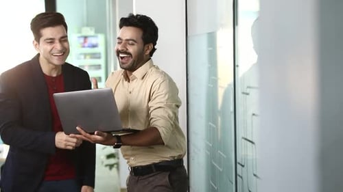 Businessmen Laughing and High Fiving in an Office